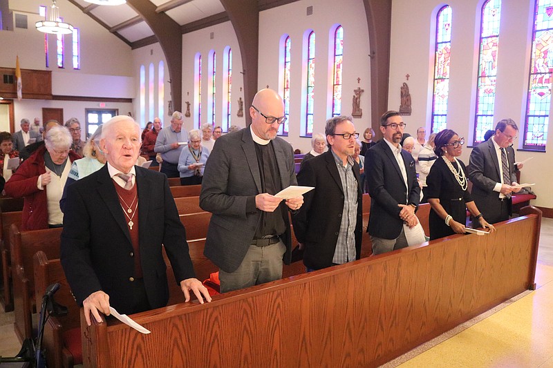 Worshippers sing a hymn during the Thanksgiving service in the sanctuary of St. Frances Cabrini Church.