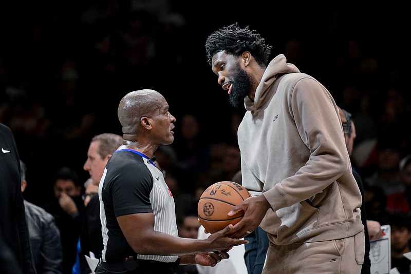 Nov 2, 2025; Brooklyn, New York, USA; Philadelphia 76ers center Joel Embiid (21) chats with referee Derrick Collins (11) during the second half at Barclays Center. Mandatory Credit: John Jones-Imagn Images