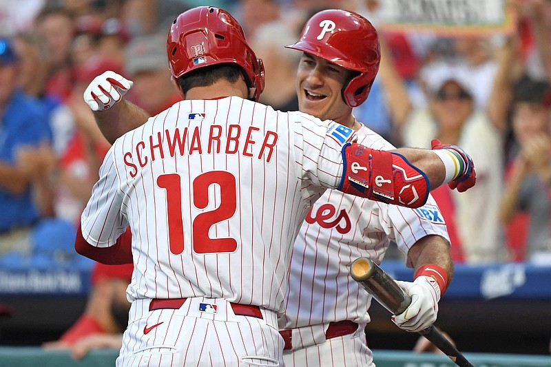 Aug 19, 2025; Philadelphia, Pennsylvania, USA; Philadelphia Phillies outfielder Kyle Schwarber (12) celebrates his home run with catcher J.T. Realmuto (10) during the first inning against the Seattle Mariners at Citizens Bank Park. Mandatory Credit: Eric Hartline-Imagn Images