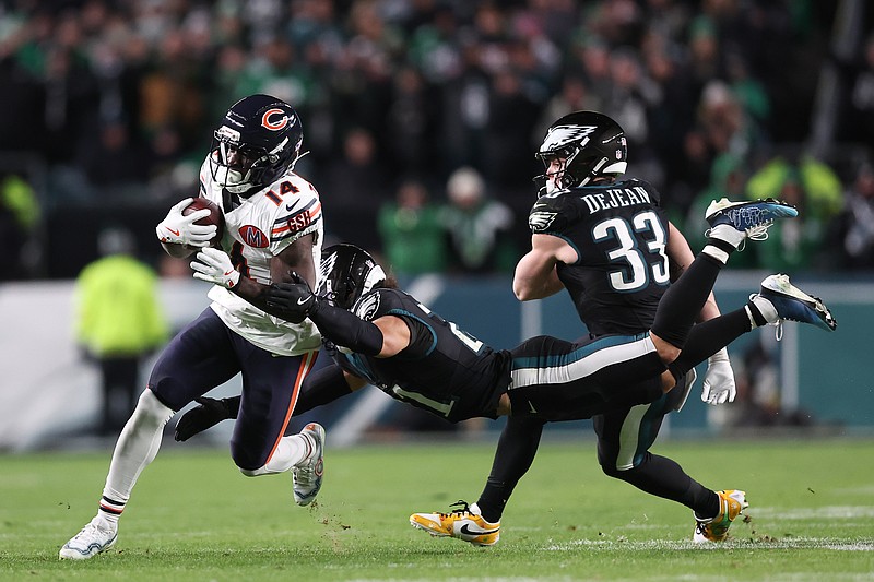 Nov 28, 2025; Philadelphia, Pennsylvania, USA; Chicago Bears wide receiver Olamide Zaccheaus (14) avoids a tackle by Philadelphia Eagles safety Sydney Brown (21) during the fourth quarter of the game at Lincoln Financial Field. Mandatory Credit: Bill Streicher-Imagn Images