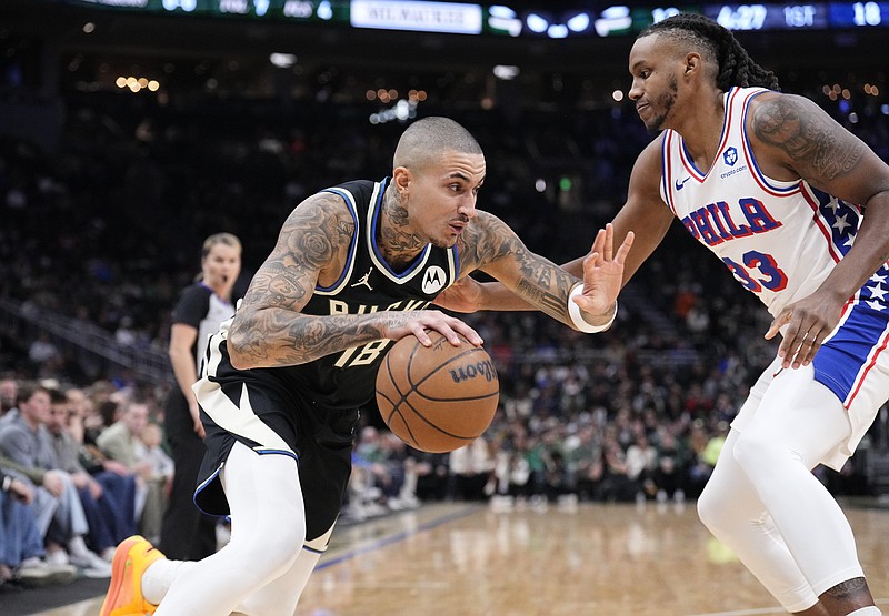 Dec 5, 2025; Milwaukee, Wisconsin, USA; Milwaukee Bucks forward Kyle Kuzma (18) drives to the basket against Philadelphia 76ers forward Jabari Walker (33) in the first half at Fiserv Forum. Mandatory Credit: Michael McLoone-Imagn Images