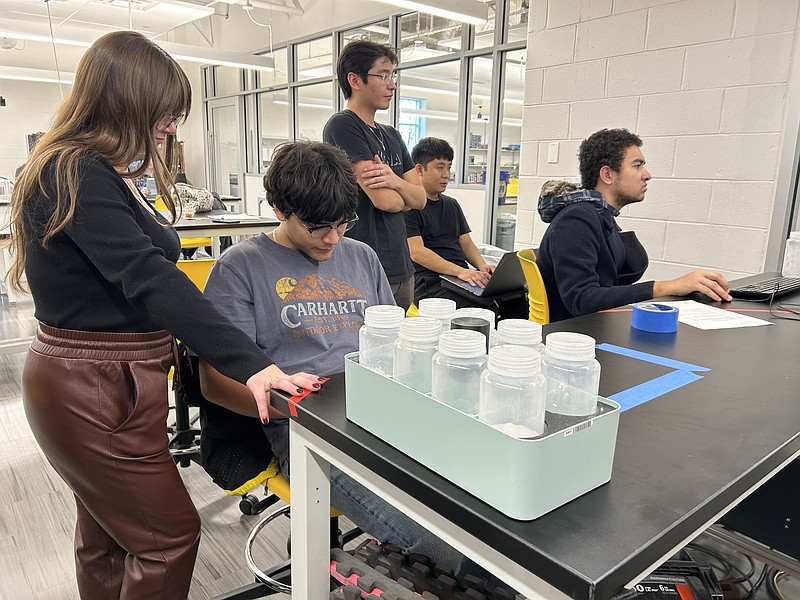 (From right) Montgomery County Community College Computer Science majors Joshua Jang and Kyle Alcantara, Mechanical Engineering major Van-Allen Schmidt, Electrical Engineering major Miguel Grimaldos-Garcia and Engineering major Stefania Schianodicola work together on the Merck Automation and Innovation Challenge. Photo by Eric Devlin