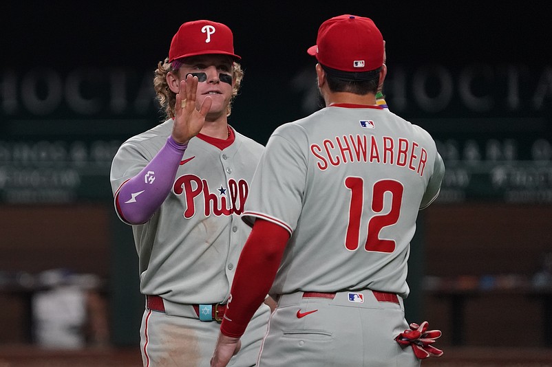 Aug 9, 2025; Arlington, Texas, USA; Philadelphia Phillies outfielder Harrison Bader (2) high fives outfielder Kyle Schwarber (12) following a game against the Texas Rangers at Globe Life Field. Mandatory Credit: Raymond Carlin III-Imagn Images