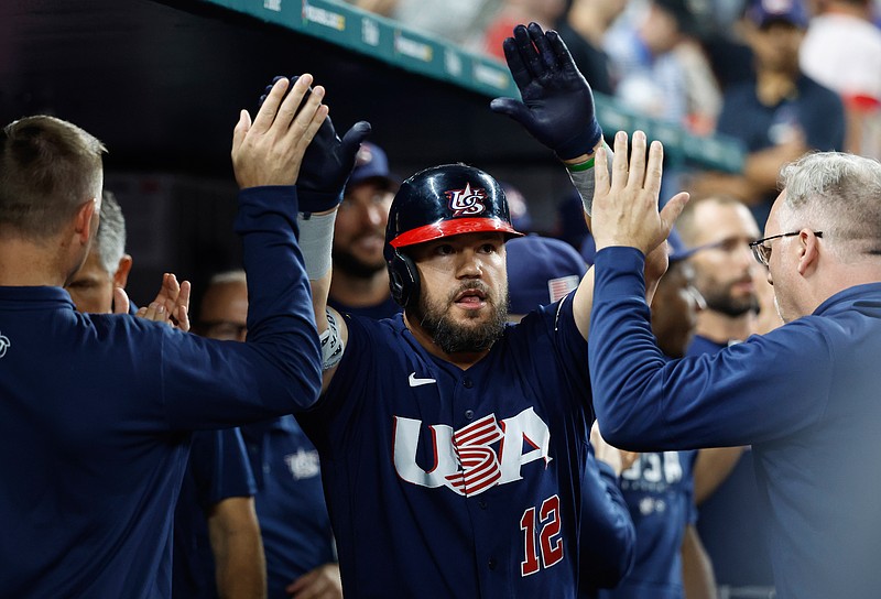 Mar 21, 2023; Miami, Florida, USA; USA designated hitter Kyle Schwarber (12) celebrates with teammates after hitting a home run against Japan in the eighth inning at LoanDepot Park. Mandatory Credit: Rhona Wise-USA TODAY Sports