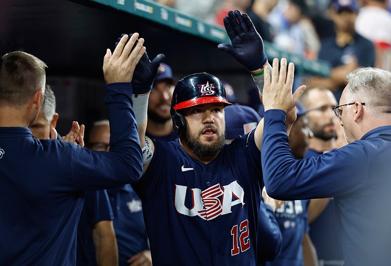 Mar 21, 2023; Miami, Florida, USA; USA designated hitter Kyle Schwarber (12) celebrates with teammates after hitting a home run against Japan in the eighth inning at LoanDepot Park. Mandatory Credit: Rhona Wise-USA TODAY Sports