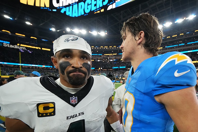 Dec 8, 2025; Inglewood, California, USA; Los Angeles Chargers quarterback Justin Herbert (10) embraces Philadelphia Eagles quarterback Jalen Hurts (1) after the game at SoFi Stadium. Mandatory Credit: Kirby Lee-Imagn Images