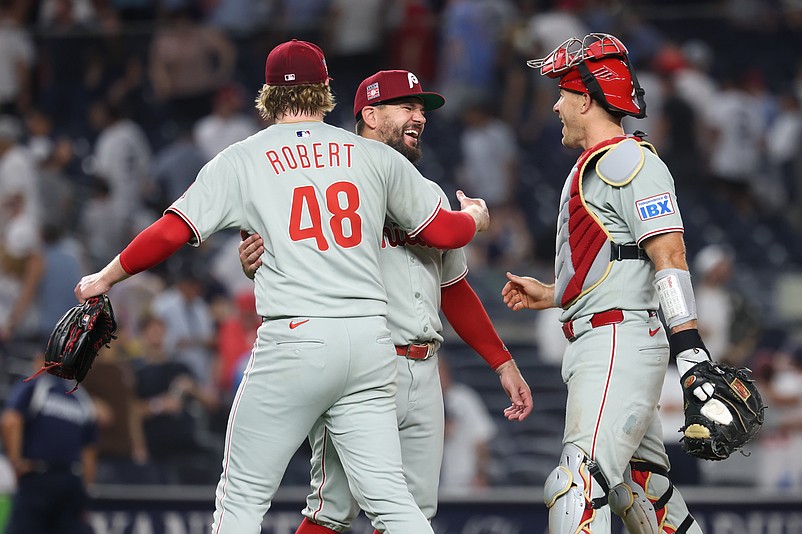 Jul 25, 2025; Bronx, New York, USA; Philadelphia Phillies relief pitcher Daniel Robert (48) and designated hitter Kyle Schwarber (12) and catcher J.T. Realmuto (10) celebrates after the game against the New York Yankees at Yankee Stadium. Mandatory Credit: Vincent Carchietta-Imagn Images