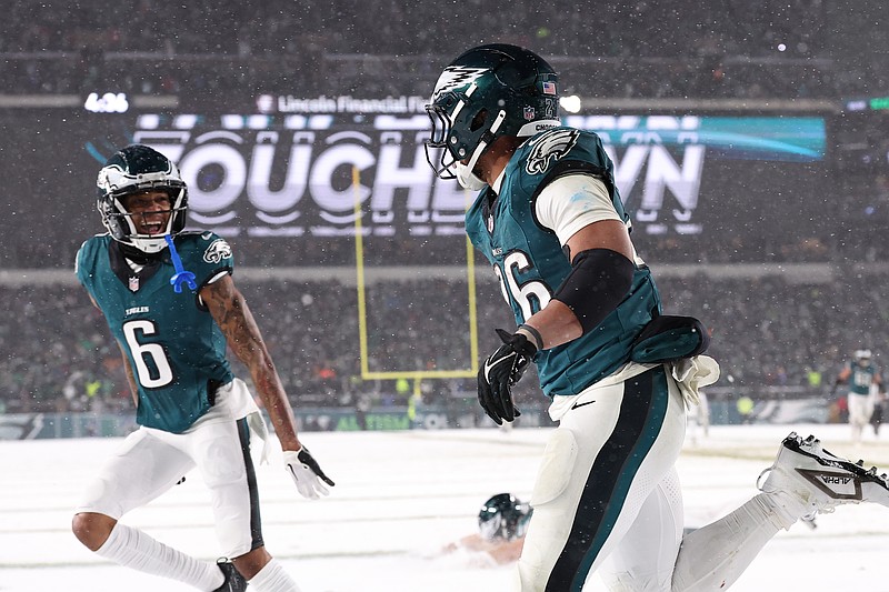 Jan 19, 2025; Philadelphia, Pennsylvania, USA; Philadelphia Eagles running back Saquon Barkley (26) celebrates alongside wide receiver DeVonta Smith (6) after his touchdown run during the fourth quarter against the Los Angeles Rams in a 2025 NFC divisional round game at Lincoln Financial Field. Mandatory Credit: Bill Streicher-Imagn Images