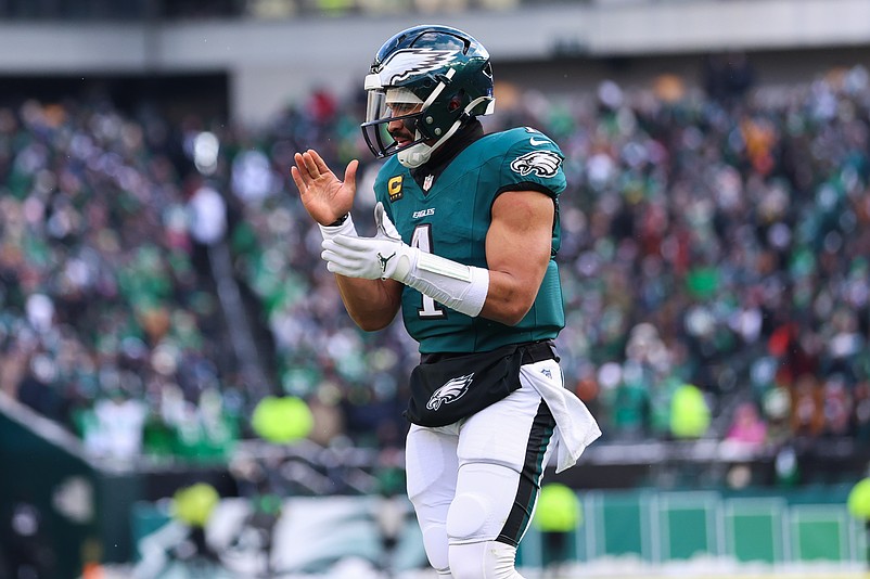 Dec 14, 2025; Philadelphia, Pennsylvania, USA; Philadelphia Eagles quarterback Jalen Hurts (1) reacts after running back Saquon Barkley (26) (not pictured) scores a touchdown against the Las Vegas Raiders during the second quarter at Lincoln Financial Field. Mandatory Credit: Bill Streicher-Imagn Images