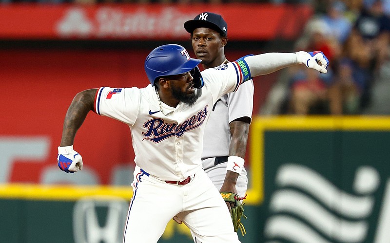 Aug 5, 2025; Arlington, Texas, USA;  Texas Rangers right fielder Adolis Garcia (53) celebrates in front of New York Yankees second baseman Jazz Chisholm Jr. (13) after hitting a double during the eighth inning at Globe Life Field. Mandatory Credit: Kevin Jairaj-Imagn Images