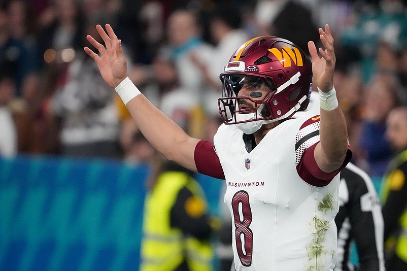 Nov 16, 2025; Madrid, Spain; Washington Commanders quarterback Marcus Mariota (8) reacts after a play against the Miami Dolphins in the third quarter during the 2025 NFL Madrid Game at Santiago Bernabeu Stadium. Mandatory Credit: Kirby Lee-Imagn Images