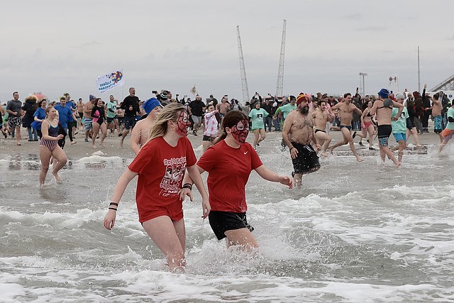 Plungers wade into the chilly surf during the 2025 Polar Bear Plunge. (Courtesy of PlungeWildwood.org)