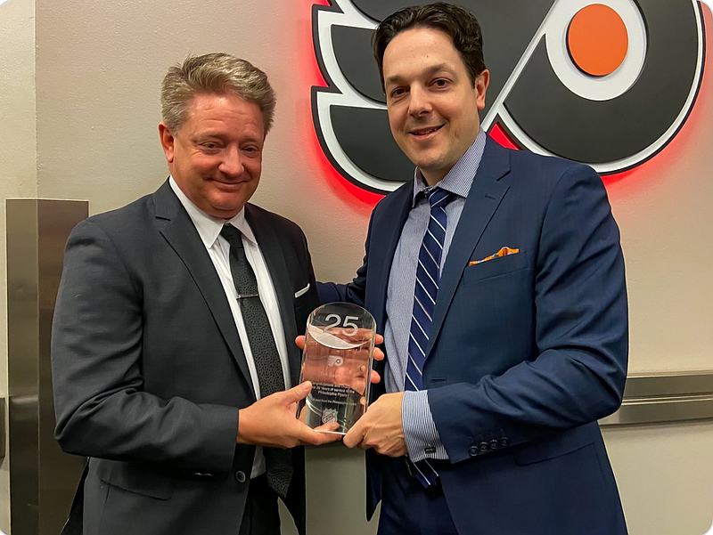 Flyers radio play-by-play announcer Tim Saunders and Flyers General Manager Danny Briere. (Courtesy @NHLFlyers on X)