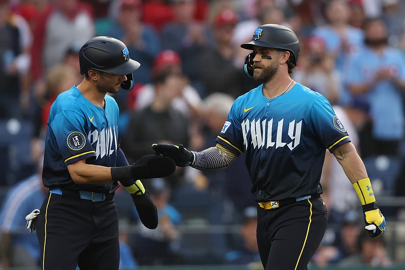 Apr 18, 2025; Philadelphia, Pennsylvania, USA; Philadelphia Phillies first base Bryce Harper (3) reacts with shortstop Trea Turner (7) after hitting a two RBI home run against the Miami Marlins during the first inning at Citizens Bank Park. Mandatory Credit: Bill Streicher-Imagn Images