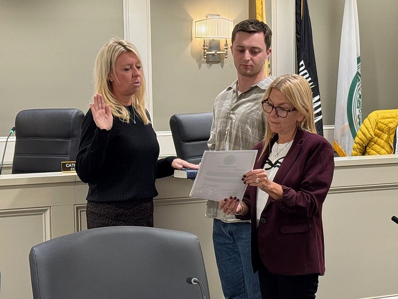 Margate Commissioner Cathy Horn administers the oath of office for newly appointed Court Administrator Deanna Krupp while Robbie Nowrocki holds the Bible.
