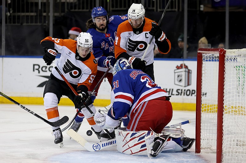 Dec 20, 2025; New York, New York, USA; New York Rangers goaltender Igor Shesterkin (31) plays the puck against Philadelphia Flyers centers Denver Barkey (52) and Sean Couturier (14) during the first period at Madison Square Garden. Mandatory Credit: Brad Penner-Imagn Images