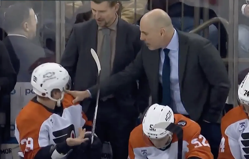 Screenshot of Rick Tocchet and Matvei Michkov chatting on the bench during a 5-4 loss to the New York Rangers on Dec. 20, 2025. (From TVA Sports You Tube page, which included a snippet of the NBCS Philadelphia broadcast).