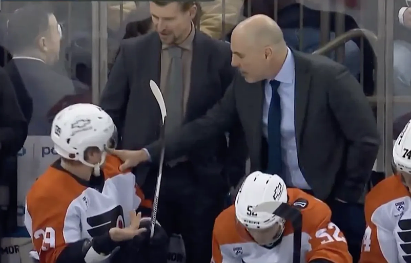 Screenshot of Rick Tocchet and Matvei Michkov chatting on the bench during a 5-4 loss to the New York Rangers on Dec. 20, 2025. (From TVA Sports You Tube page, which included a snippet of the NBCS Philadelphia broadcast).