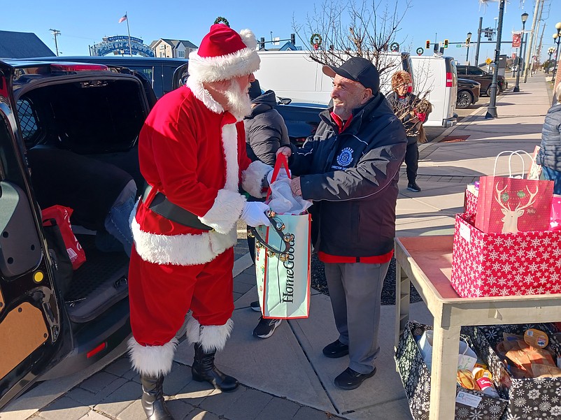 Santa Claus gives Mayor Leonard Desiderio a hand during the Mayor’s Toy & Food Drive.
