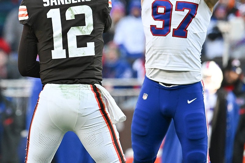 Dec 21, 2025; Cleveland, Ohio, USA;  Buffalo Bills defensive end Joey Bosa (97) tips the pass by Cleveland Browns quarterback Shedeur Sanders (12) which then was later intercepted on the play during the second half at Huntington Bank Field. Mandatory Credit: Ken Blaze-Imagn Images