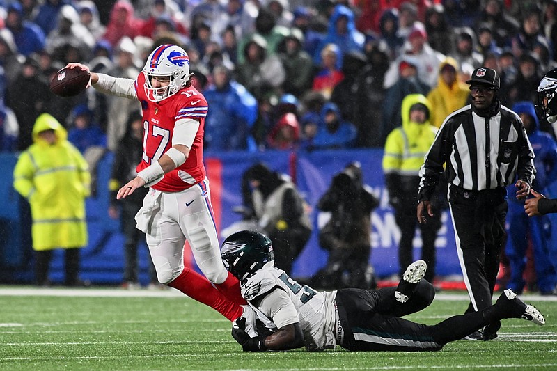 Dec 28, 2025; Orchard Park, New York, USA; Philadelphia Eagles linebacker Jaelan Phillips (50) tackles Buffalo Bills quarterback Josh Allen (17) during the first quarter at Highmark Stadium. Mandatory Credit: Mark Konezny-Imagn Images