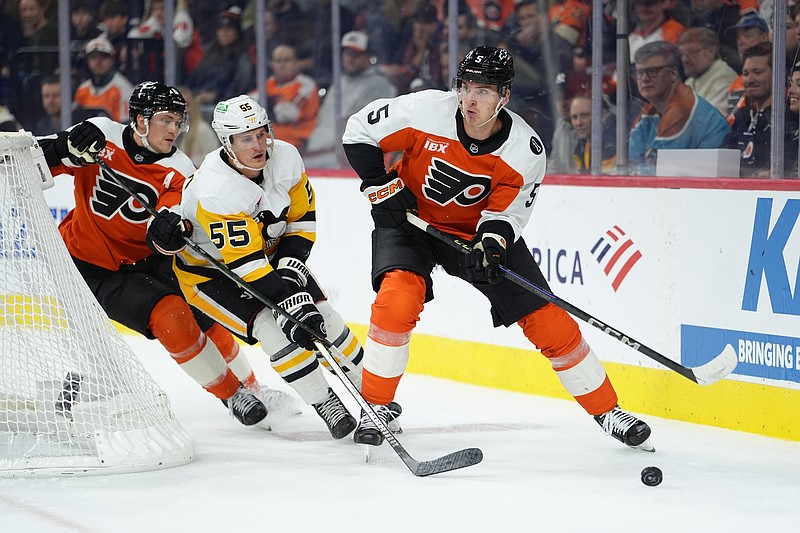 Oct 28, 2025; Philadelphia, Pennsylvania, USA; Philadelphia Flyers defenseman Egor Zamula (5) chases the puck against Pittsburgh Penguins center Noel Acciari (55) in the second period at Xfinity Mobile Arena. Mandatory Credit: Kyle Ross-Imagn Images