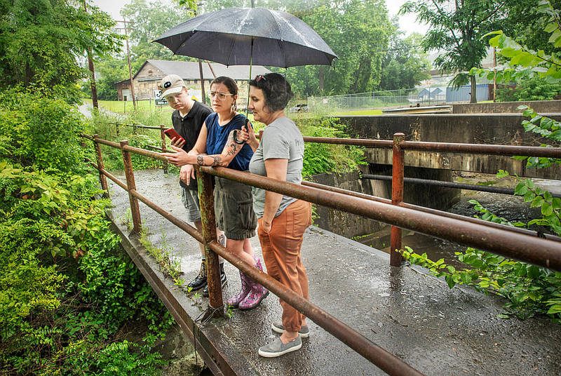 Yvonne Sorovacu (right), Hannah Hohman (center) and Jay Beal monitor a creek for signs of contamination from the Westmoreland Sanitary Landfill in Belle Vernon, Faytette County. (Photo by Scott Goldsmith/Inside Climate News)
