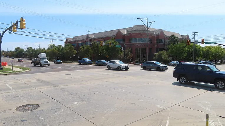Cars head past an office building discussed as the centerpiece of a possible “Main Street” development at the corner of Forty Foot Road and Sumneytown Pike in Towamencin in Sept. 2024.