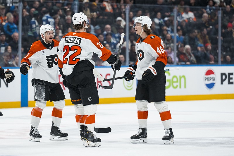 Dec 30, 2025; Vancouver, British Columbia, CAN; Philadelphia Flyers forward Travis Konecny (11) and forward Christian Dvorak (22) and forward Trevor Zegras (46) celebrate Dvorakâ€™s goal against the Vancouver Canucks in the third period at Rogers Arena. Mandatory Credit: Bob Frid-Imagn Images