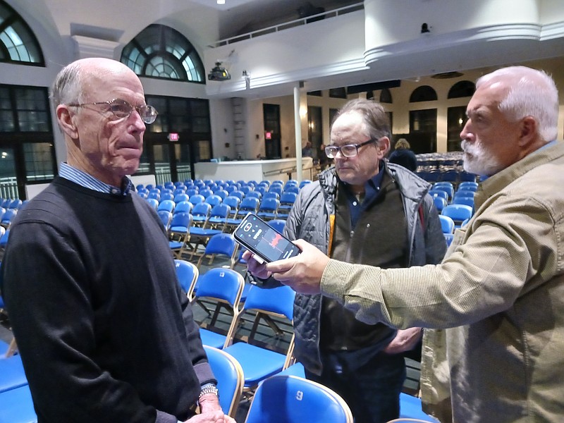 Hotel developer Eustace Mita, left, the owner of the Wonderland property, speaks to reporters after the planning board vote.