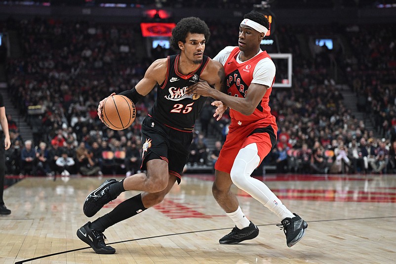 Jan 11, 2026; Toronto, Ontario, CAN;  Philadelphia 76ers forward Dominick Barlow (25) dribbles the ball against Toronto Raptors guard Ja'Kobe Walter (14) in the first half at Scotiabank Arena. Mandatory Credit: Dan Hamilton-Imagn Images