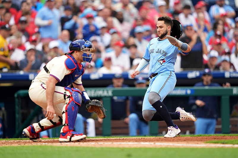 Jun 14, 2025; Philadelphia, Pennsylvania, USA; Toronto Blue Jays infielder Bo Bichette (11) slides home to score against the Philadelphia Phillies in the fifth inning at Citizens Bank Park. Mandatory Credit: Kyle Ross-Imagn Images