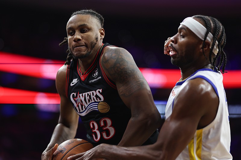 Dec 4, 2025; Philadelphia, Pennsylvania, USA; Philadelphia 76ers forward Jabari Walker (33) controls the ball against Golden State Warriors guard Buddy Hield (7) during the third quarter at Xfinity Mobile Arena. Mandatory Credit: Bill Streicher-Imagn Images