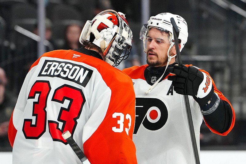 Jan 19, 2026; Las Vegas, Nevada, USA; Philadelphia Flyers right wing Travis Konecny (11) congratulates Philadelphia Flyers goaltender Samuel Ersson (33) after the Flyers defeated the Vegas Golden Knights 2-1 at T-Mobile Arena. Mandatory Credit: Stephen R. Sylvanie-Imagn Images