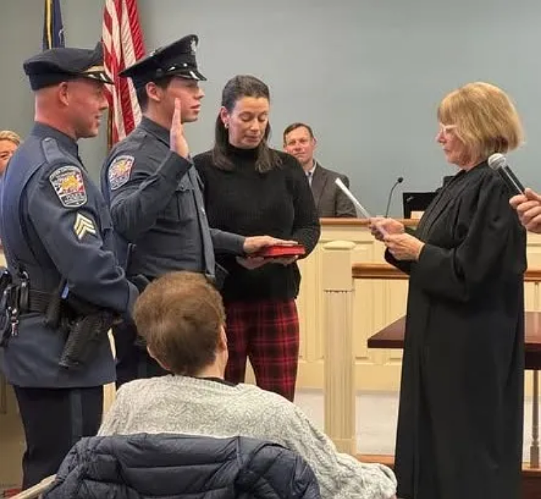 Upper Gwynedd Police Sergeant Harrison Colcher, left, listens as his son Jackson received his oath from district Judge Suzan Leonard on Monday, Jan. 12, 2026. (Photo courtesy of Upper Gwynedd Police Department)