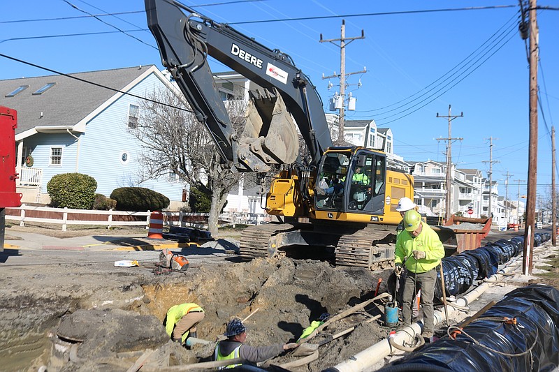 Construction workers are using heavy machinery to install the drainage pipes on Central Avenue.