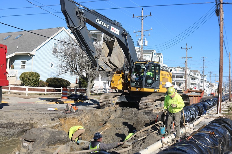 Construction workers are using heavy machinery to install the drainage pipes on Central Avenue.
