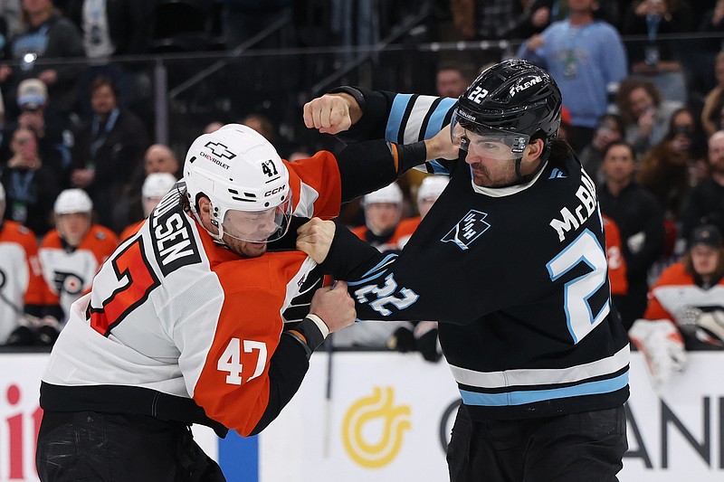 Jan 21, 2026; Salt Lake City, Utah, USA; Philadelphia Flyers defenseman Noah Juulsen (47) and Utah Mammoth center Jack McBain (22) fight during the third period at Delta Center. Mandatory Credit: Rob Gray-Imagn Images