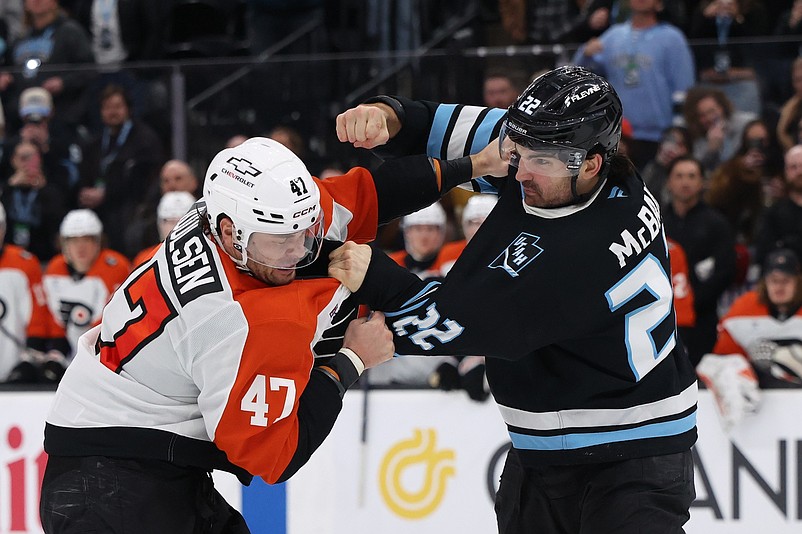 Jan 21, 2026; Salt Lake City, Utah, USA; Philadelphia Flyers defenseman Noah Juulsen (47) and Utah Mammoth center Jack McBain (22) fight during the third period at Delta Center. Mandatory Credit: Rob Gray-Imagn Images