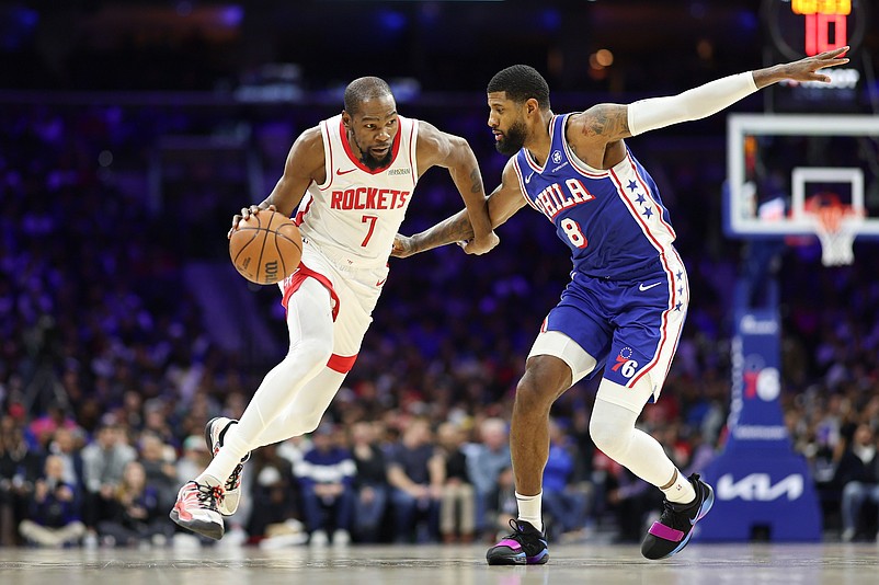 Jan 22, 2026; Philadelphia, Pennsylvania, USA; Houston Rockets forward Kevin Durant (7) drives against Philadelphia 76ers forward Paul George (8) during the fourth quarter at Xfinity Mobile Arena. Mandatory Credit: Bill Streicher-Imagn Images