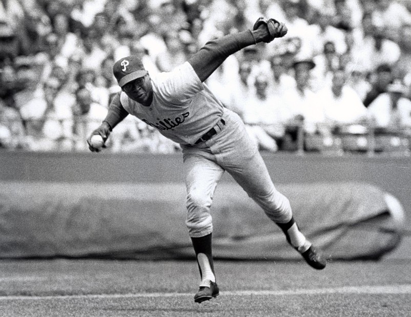 May 1965; Unknown location, USA; FILE PHOTO; Philadelphia Phillies third baseman Dick Allen in action fielding a ball. Mandatory Credit: Malcolm Emmons-USA TODAY Sports
