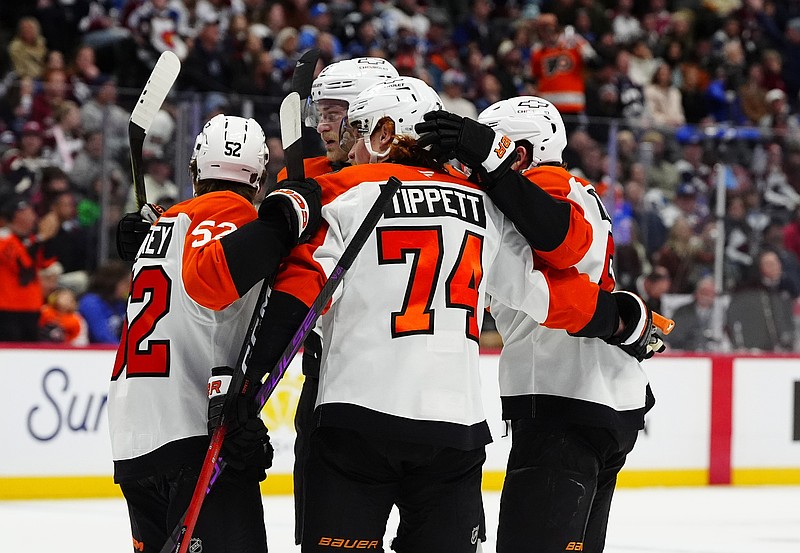 Jan 23, 2026; Denver, Colorado, USA; Philadelphia Flyers right wing Owen Tippett (74) celebrates his goal with teammates in the first period against the Colorado Avalanche at Ball Arena. Mandatory Credit: Ron Chenoy-Imagn Images