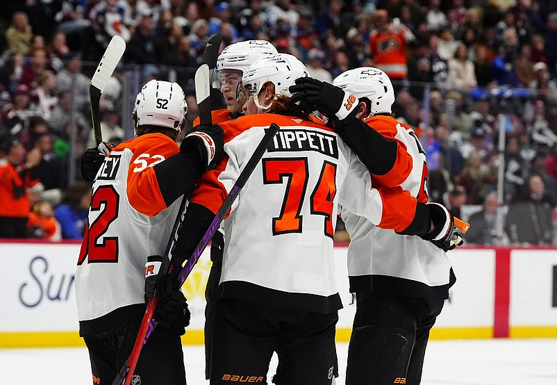 Jan 23, 2026; Denver, Colorado, USA; Philadelphia Flyers right wing Owen Tippett (74) celebrates his goal with teammates in the first period against the Colorado Avalanche at Ball Arena. Mandatory Credit: Ron Chenoy-Imagn Images