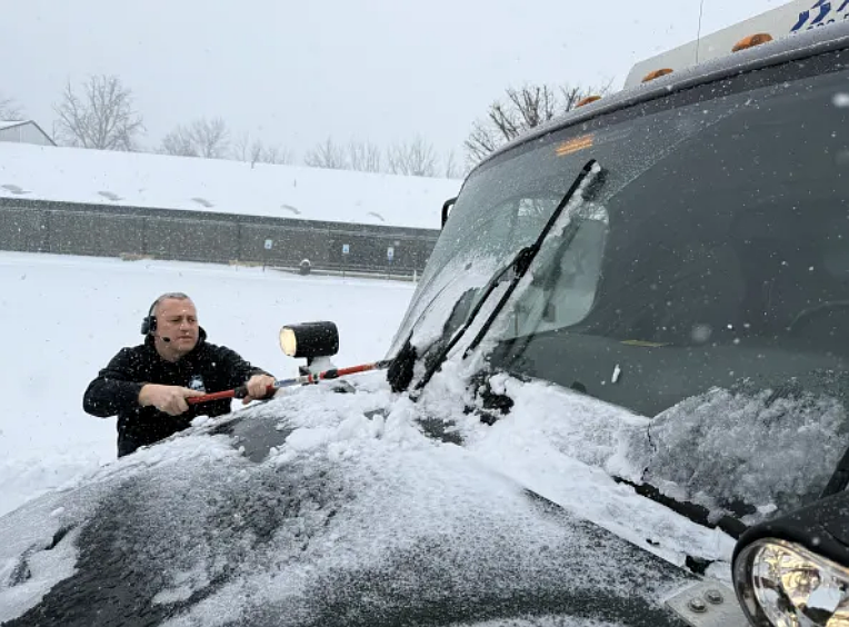 Mike Krewson of Hatfield Township’s public works department clears snow from his plow truck’s windshield before doing the same for local roads on Sunday, Jan. 25, 2026. (Photo courtesy of Hatfield Township)