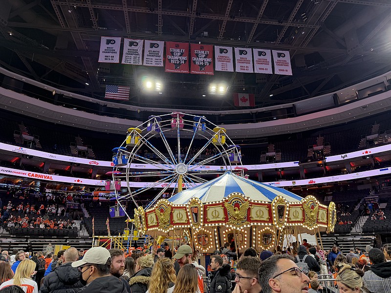 Feb. 1, 2026; The Flyers' Stanley Cup banners hang above a Ferris wheel and carousel during the 2026 Flyers Charities Carnival at Xfinity Mobile Arena.