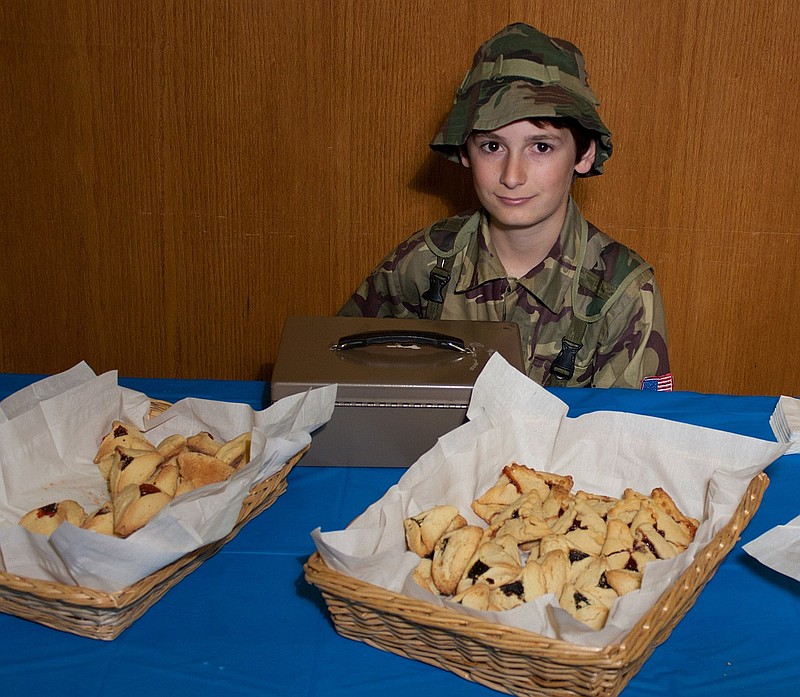 A teen guards the hammentaschen