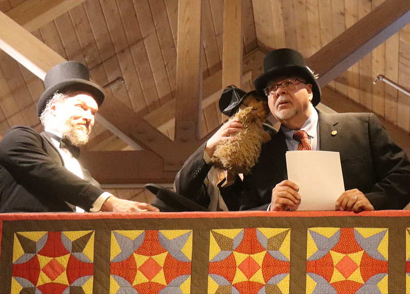 Harleysville Hank “whispers” his prediction in the ear of Hauptman Steve Hunsberger. (John Worthington – MediaNewsGroup)