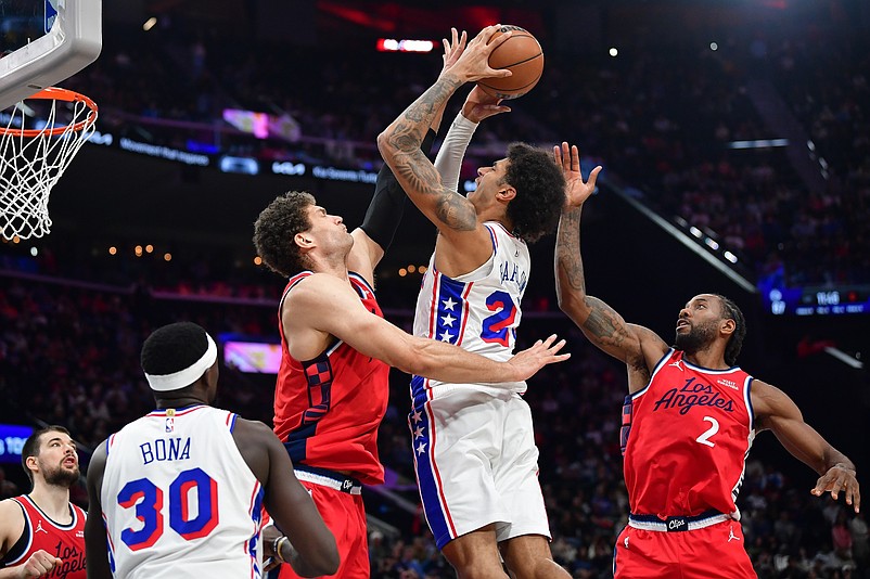 Feb 2, 2026; Inglewood, California, USA; Philadelphia 76ers forward Dominick Barlow (25) shoots against Los Angeles Clippers center Brook Lopez (11) and forward Kawhi Leonard (2) during the second half at Intuit Dome. Mandatory Credit: Gary A. Vasquez-Imagn Images