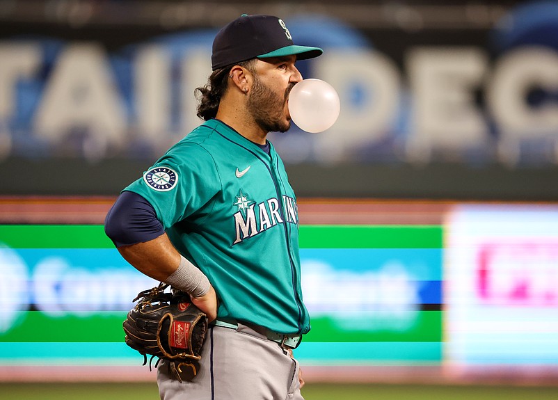 Sep 16, 2025; Kansas City, Missouri, USA; Seattle Mariners third baseman Eugenio Suarez (28) blows a bubble during a break in action in the bottom of the eighth inning against the Kansas City Royals at Kauffman Stadium. Mandatory Credit: Scott Sewell-Imagn Images