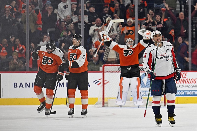 Feb 3, 2026; Philadelphia, Pennsylvania, USA; Washington Capitals left wing Alex Ovechkin (8) reacts as Philadelphia Flyers defenseman Rasmus Ristolainen (55) celebrates his empty net goal with defenseman Travis Sanheim (6) during the third period at Xfinity Mobile Arena. Mandatory Credit: Eric Hartline-Imagn Images